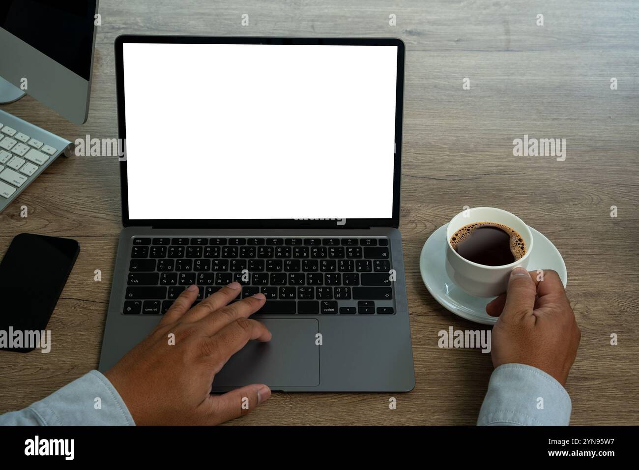 Side view man man working using a desktop computer of the blank screen Stock Photo