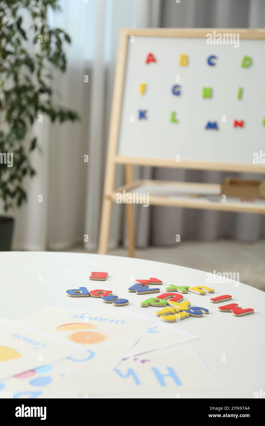 Learning alphabet. Different magnetic letters and pictures on white ...