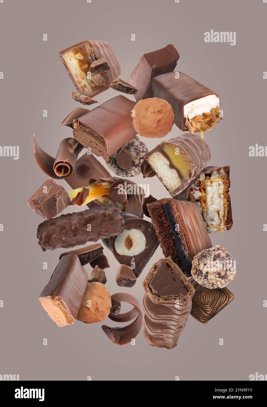 Different chocolate products in air on grey background Stock Photo