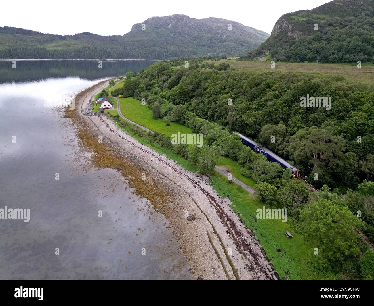 Scotrail Inverness to Kyle train service approaching Plockton alongside Loch Carron, Scotland, July 2024 Stock Photo