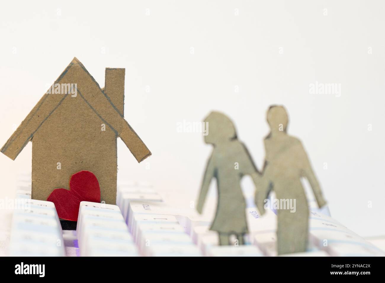 Paper house with red heart and family on white background. Love concept ...