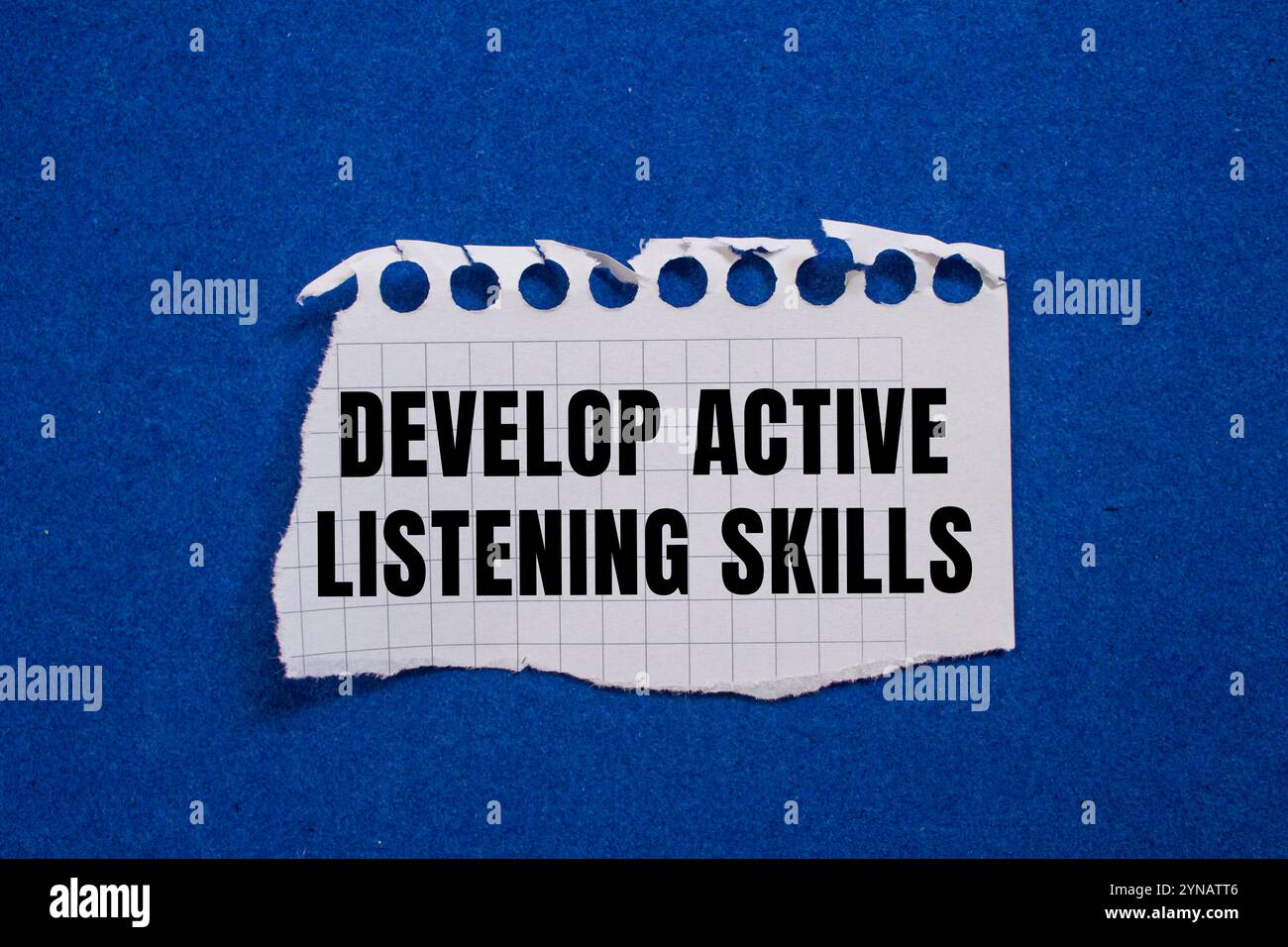 Develop active listening skills message written on ripped torn paper ...
