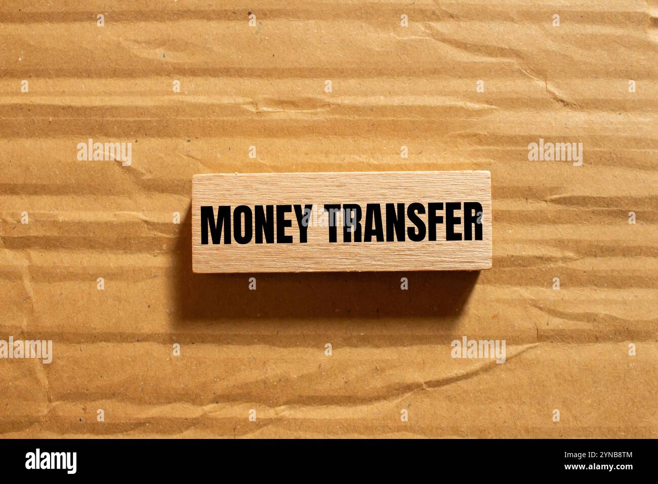 Money transfer message written on wooden block with cardboard ...
