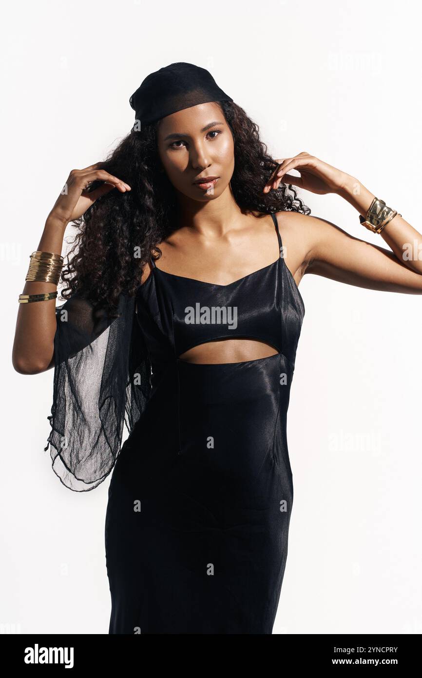 This stunning woman showcases her fashion sense with a unique black ensemble, exuding confidence. Stock Photo