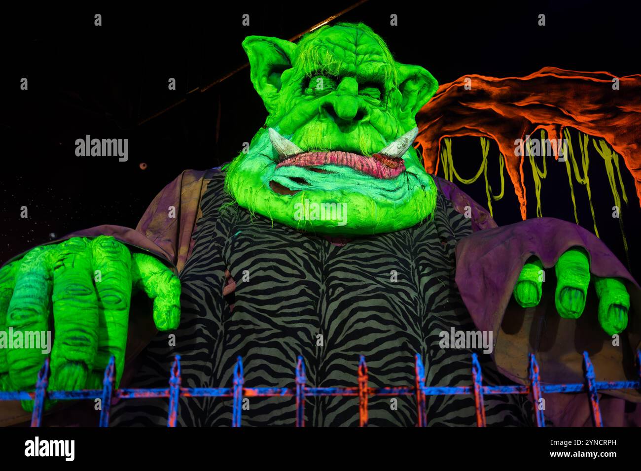 Monster Mini Golf Interior Chantilly Virginia // CHANTILLY, Virginia — The interior of Monster Mini Golf features vibrant UV-reactive decorations and neon artwork illuminated by blacklights throughout the indoor mini golf course. The facility combines monster-themed elements with fluorescent colors to create an immersive glow-in-the-dark putting experience. Stock Photo