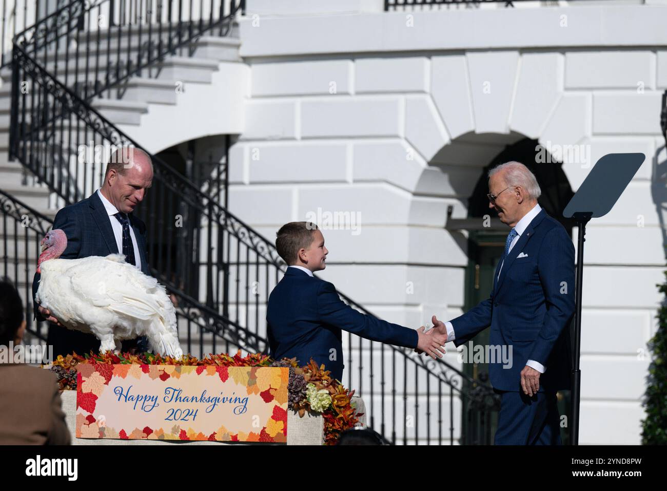 Washington, USA. 25th Nov, 2024. United States President Joe Biden shakes hands with Grant Zimmerman, son of the Chair of the National Turkey Federation John Zimmerman at the Thanksgiving Turkey Celebration on the South Lawn of the White House in Washington, DC on November 25, 2024. (Photo by Annabelle Gordon/Sipa USA). Credit: Sipa USA/Alamy Live News Stock Photo