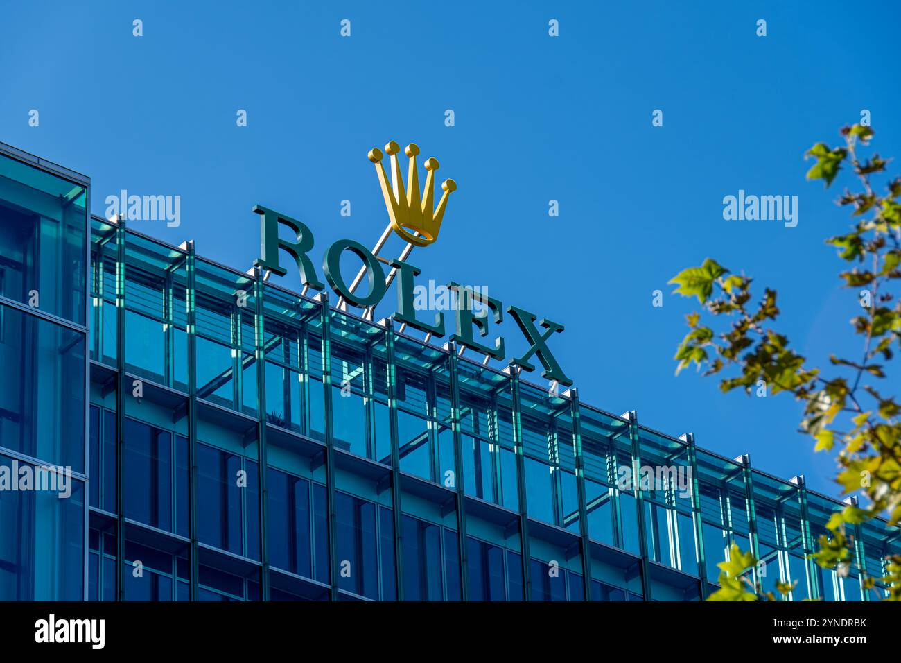 Sign and logo at the top of the Rolex headquarters building. Rolex is a Swiss watch manufacturer and the world's leading luxury watch brand Stock Photo