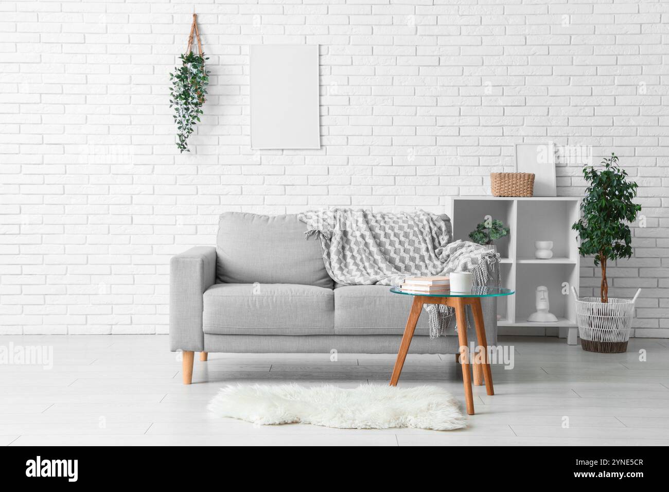 Interior of living room with cozy sofa, coffee table and shelving unit ...