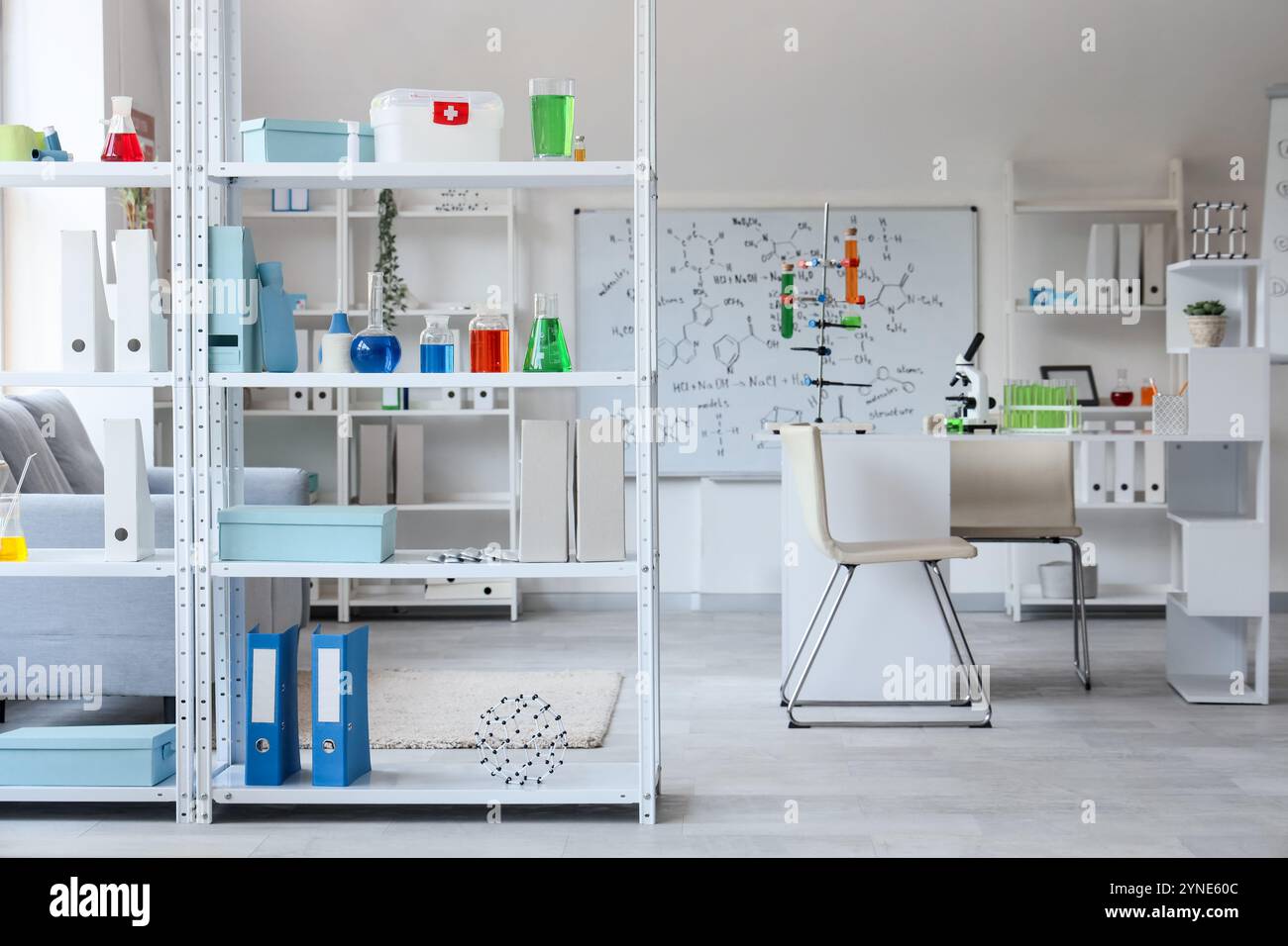Interior of laboratory with workplace, shelf units and chemical ...