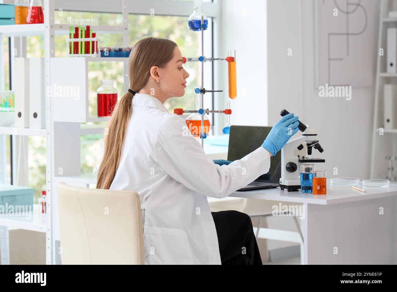 Female chemist microscope table hi-res stock photography and images - Alamy