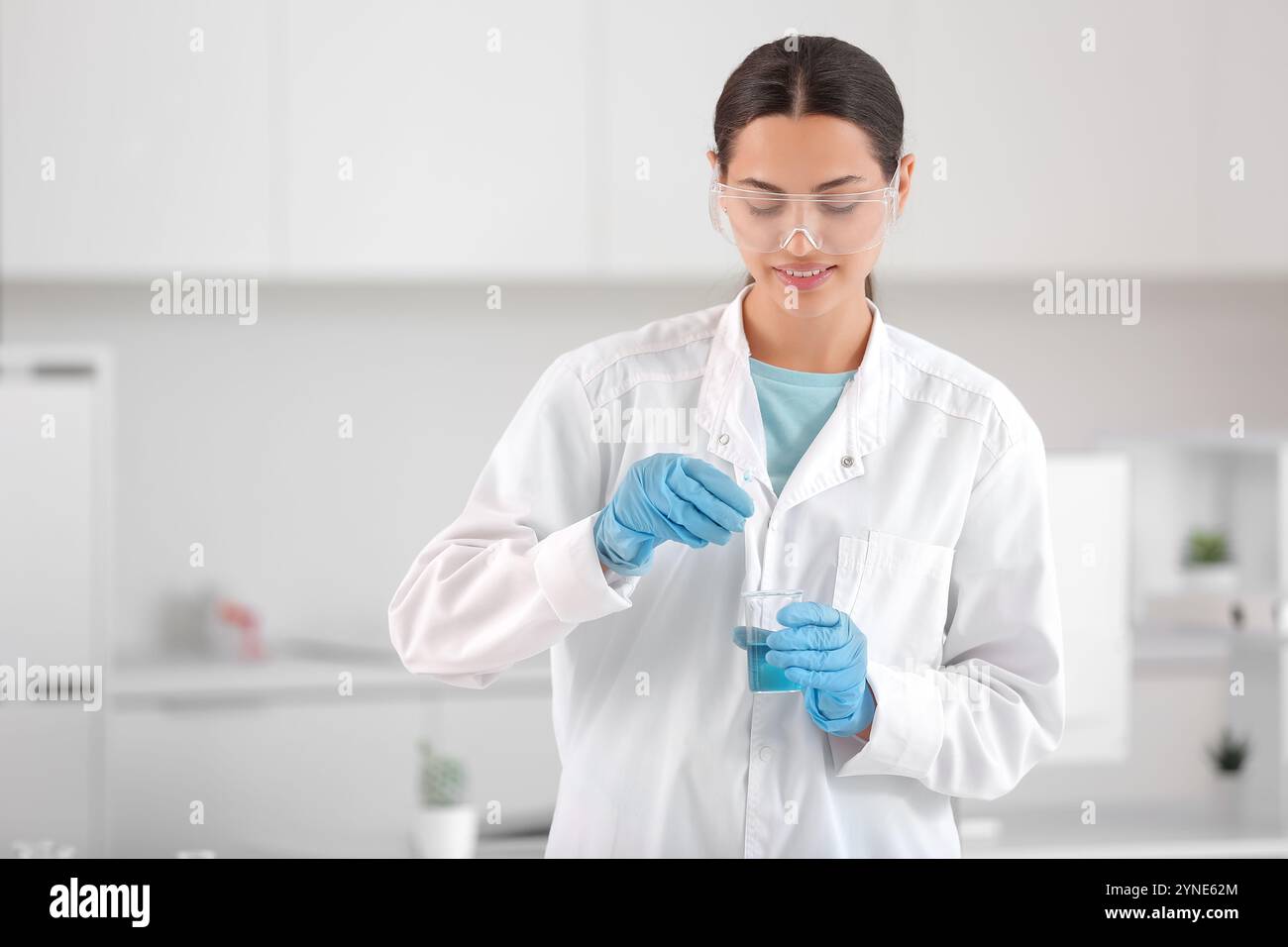 Happy female young scientist examining water quality in research ...