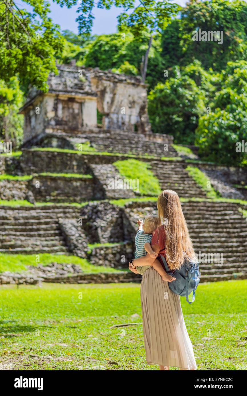 Mother and son tourists exploring the ancient pyramids of Palenque ...