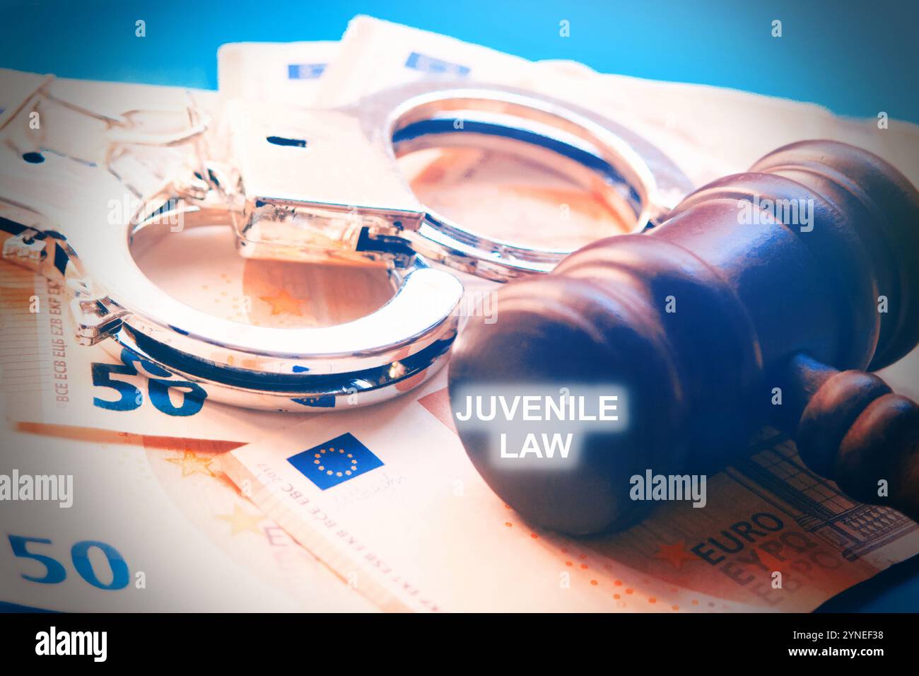 Juvenile Law conceptual photo, with gavel with handcuffs, euro notes as background, close up. Stock Photo