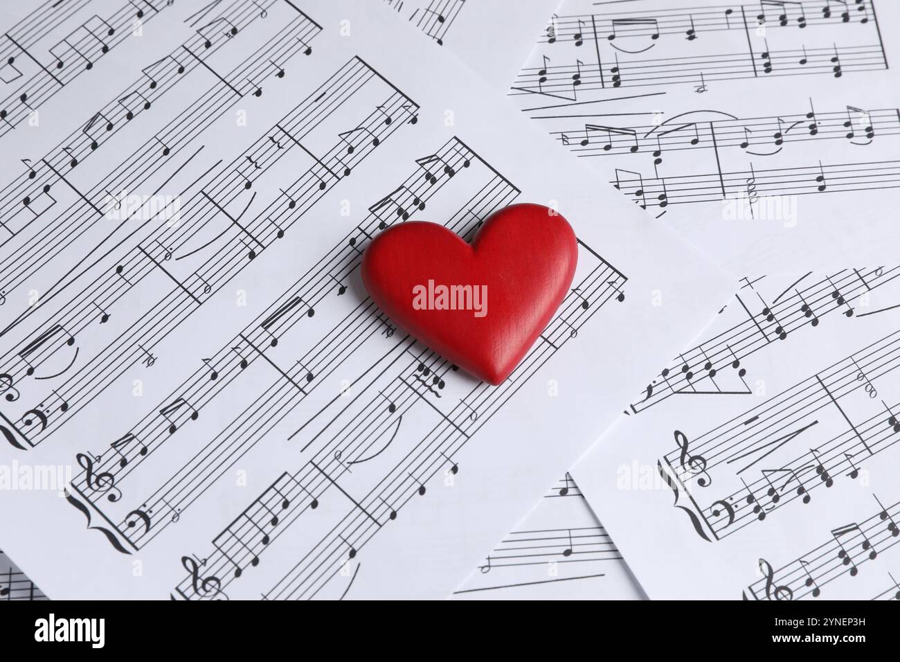 Heart figure on musical note sheets, closeup Stock Photo