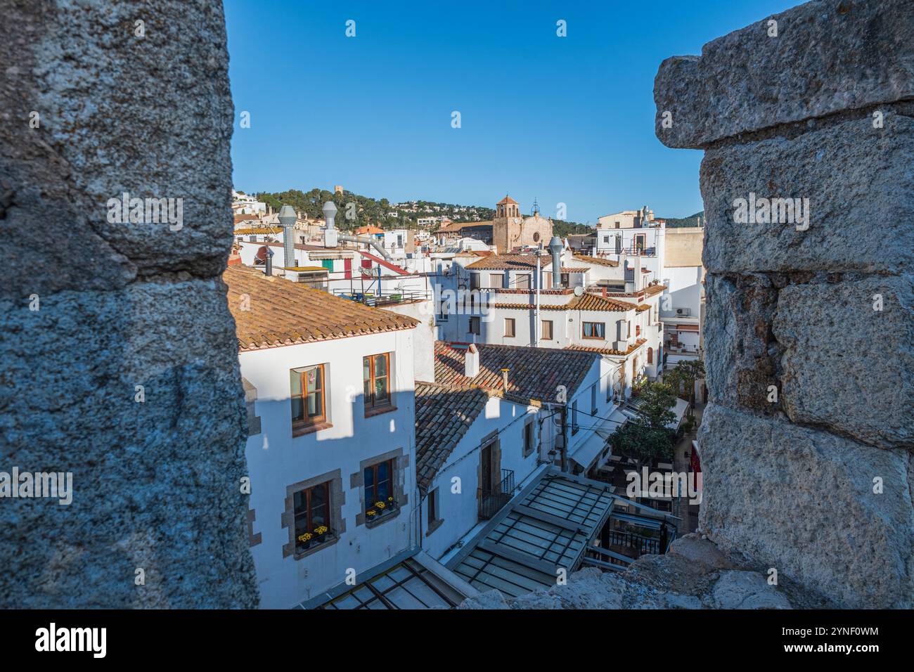 A glimpse from the medieval fortified walls of the village of Tossa de Mar, located on the beautiful Costa Brava, north of Barcelona, in Spain. Stock Photo