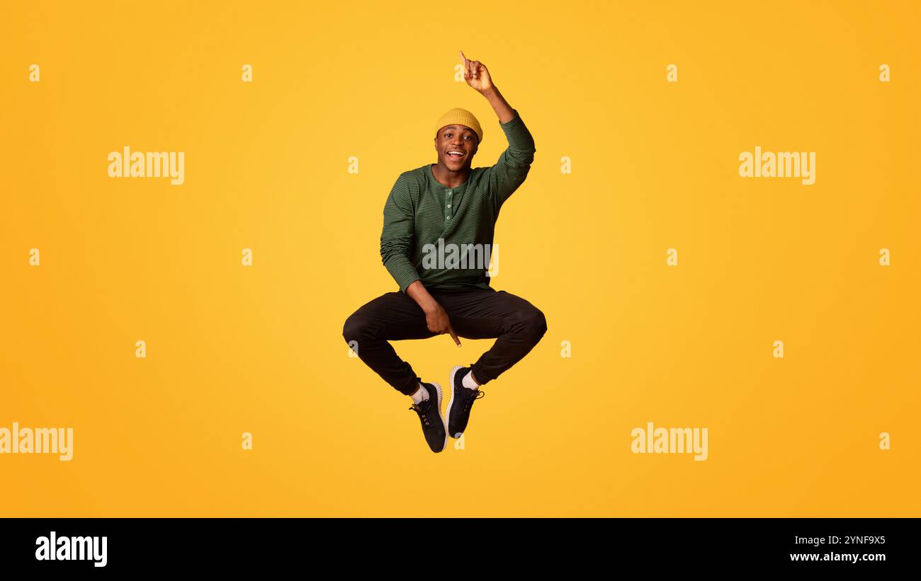 Excited guy pointing black hi-res stock photography and images - Alamy