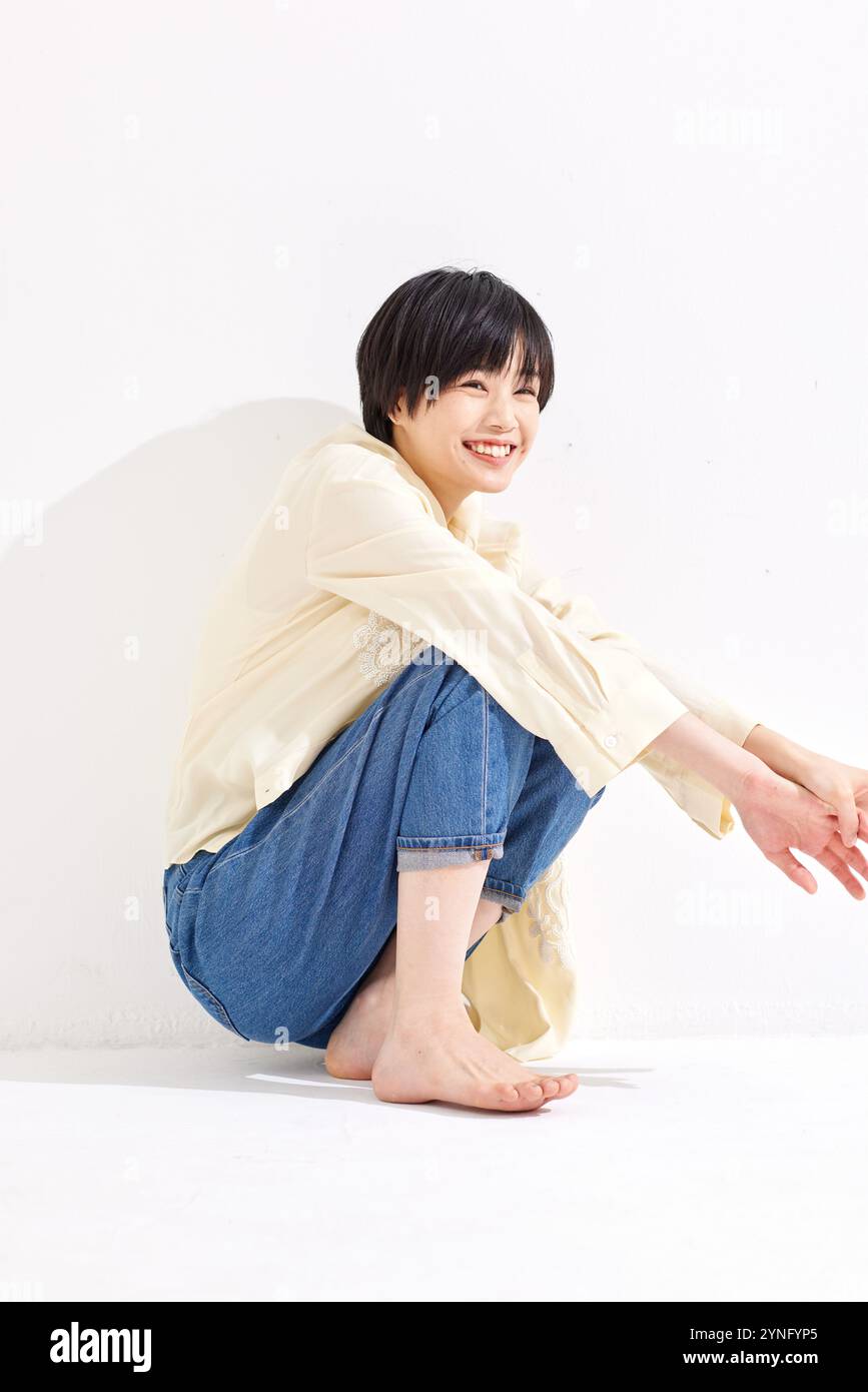 Studio shot woman sitting knees hi-res stock photography and images - Alamy