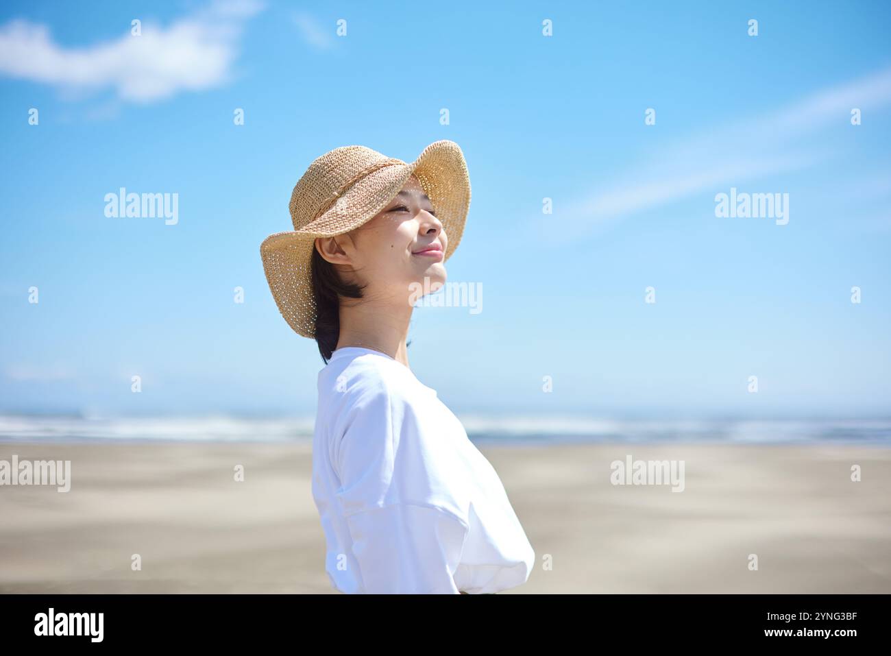 Happy young Japanese woman at the beach Stock Photo - Alamy