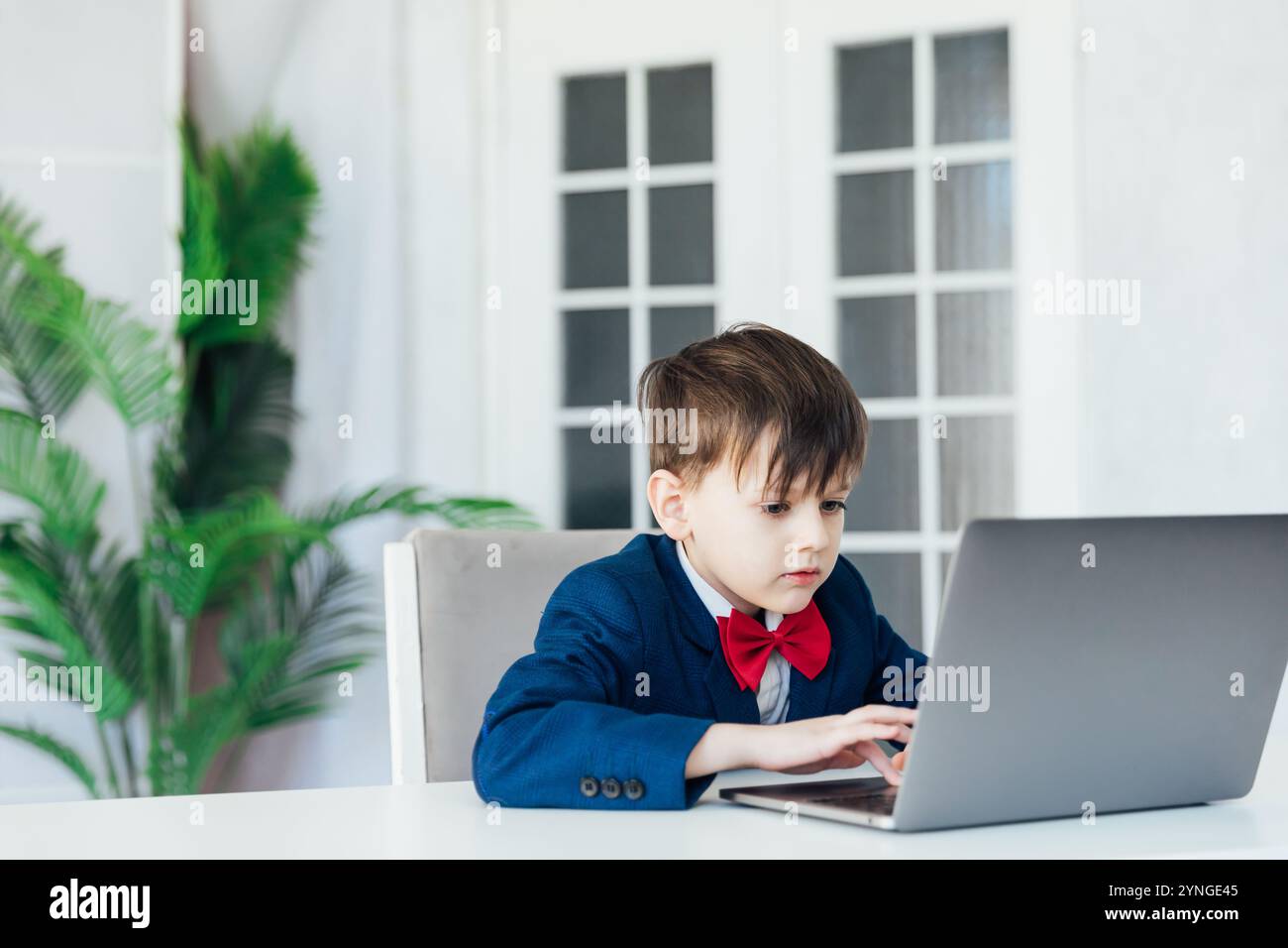 Schoolboy At Desk Playing In Laptop Stock Photo - Alamy