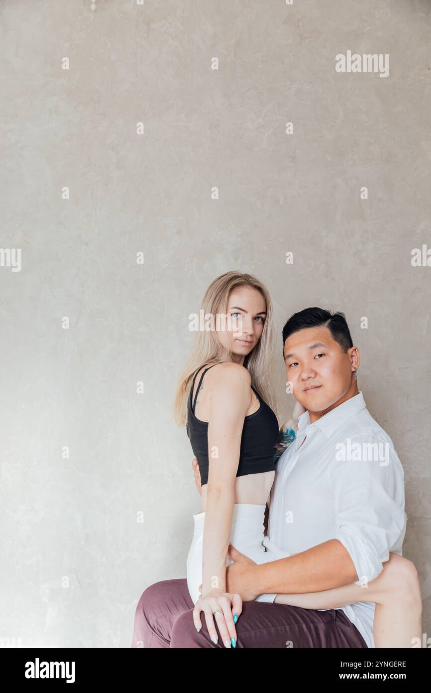 Man And Woman Sitting Together Side By Side Hugging Stock Photo - Alamy