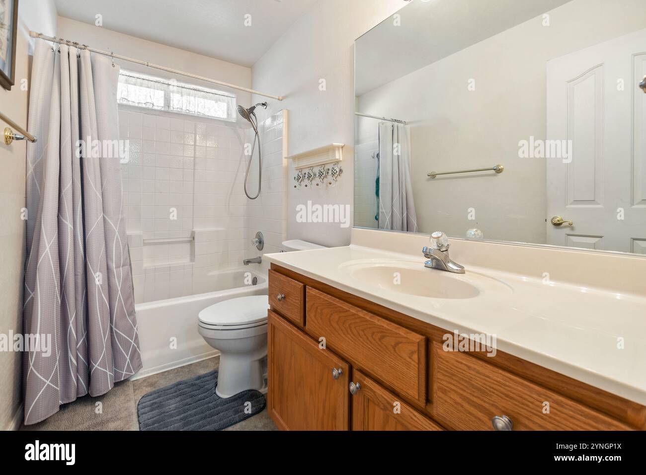 Elegant and spacious bathroom with modern fixtures and soothing colors Stock Photo