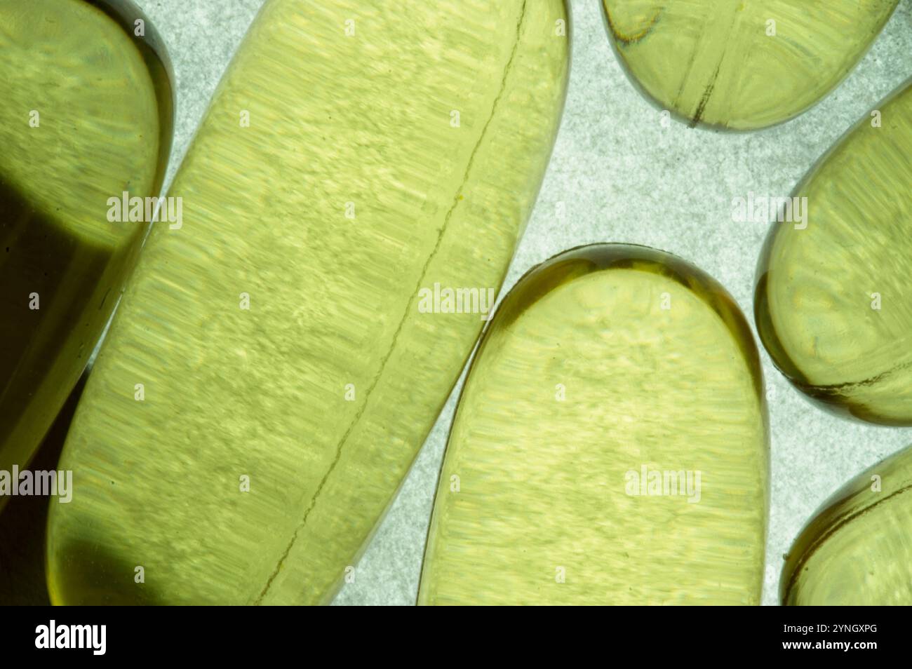 Gelcap supplement pills on a lighted background for an abstract image Stock Photo