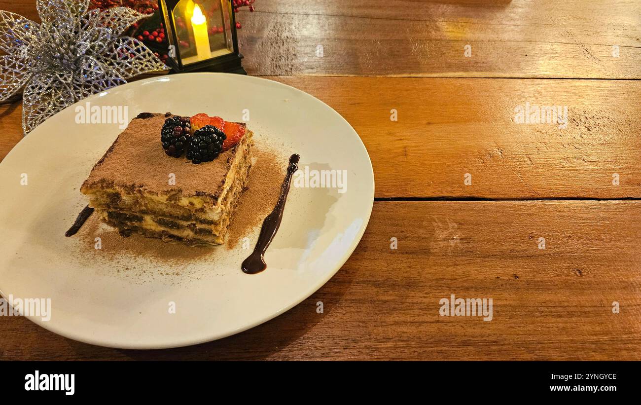 Tiramisu is a cold cake that is assembled in layers. This dessert has its origins in northeast Italy prepared with coffee, sponge cake, egg yolks Stock Photo