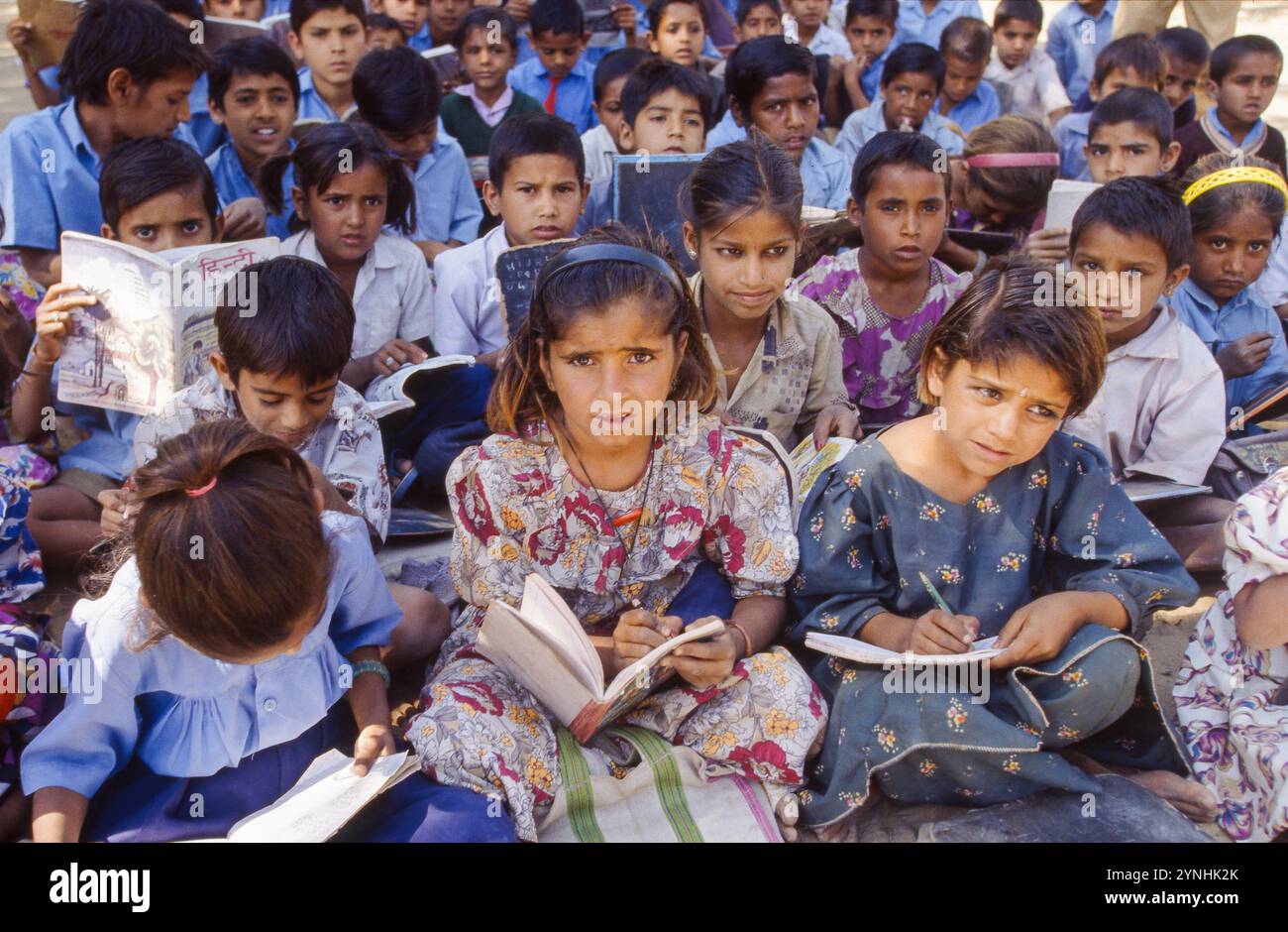 India, Rajasthan, primary school class having lessons outside between ...