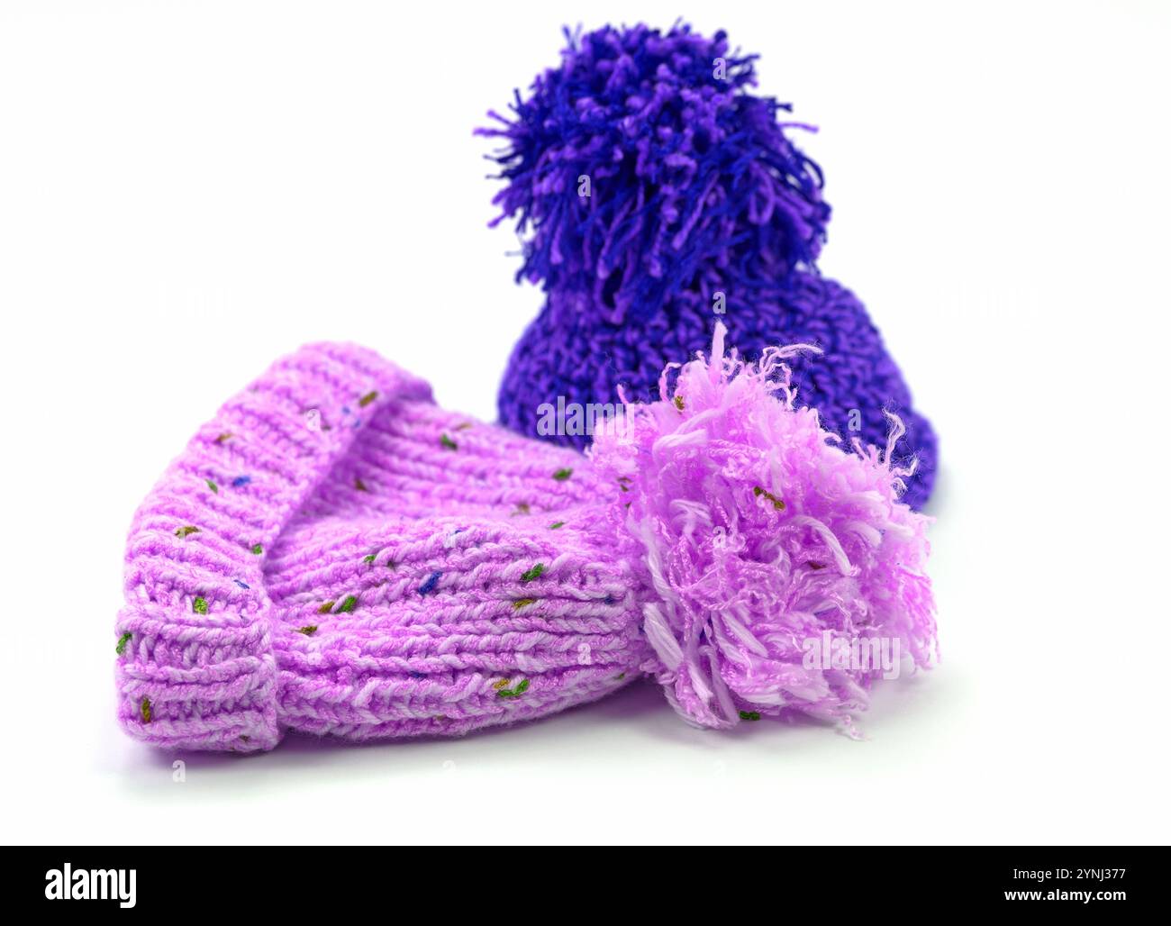 Two bobble hats against a white background Stock Photo