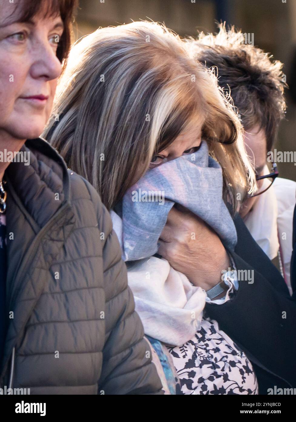 Jacqueline Higson obscures her face as she leaves Bradford Crown Court, after receiving a suspended prison sentence after she pleaded guilty to causing the death of a motorcyclist, Darron Coster, who was hailed as a hero following the Manchester Arena bombing. Higson has pleaded guilty to one charge of causing the death of 54-year-old Mr Coster by careless driving following a collision between her car and his bike near Skipton, in North Yorkshire, in July 2021. Picture date: Tuesday November 26, 2024. Stock Photo