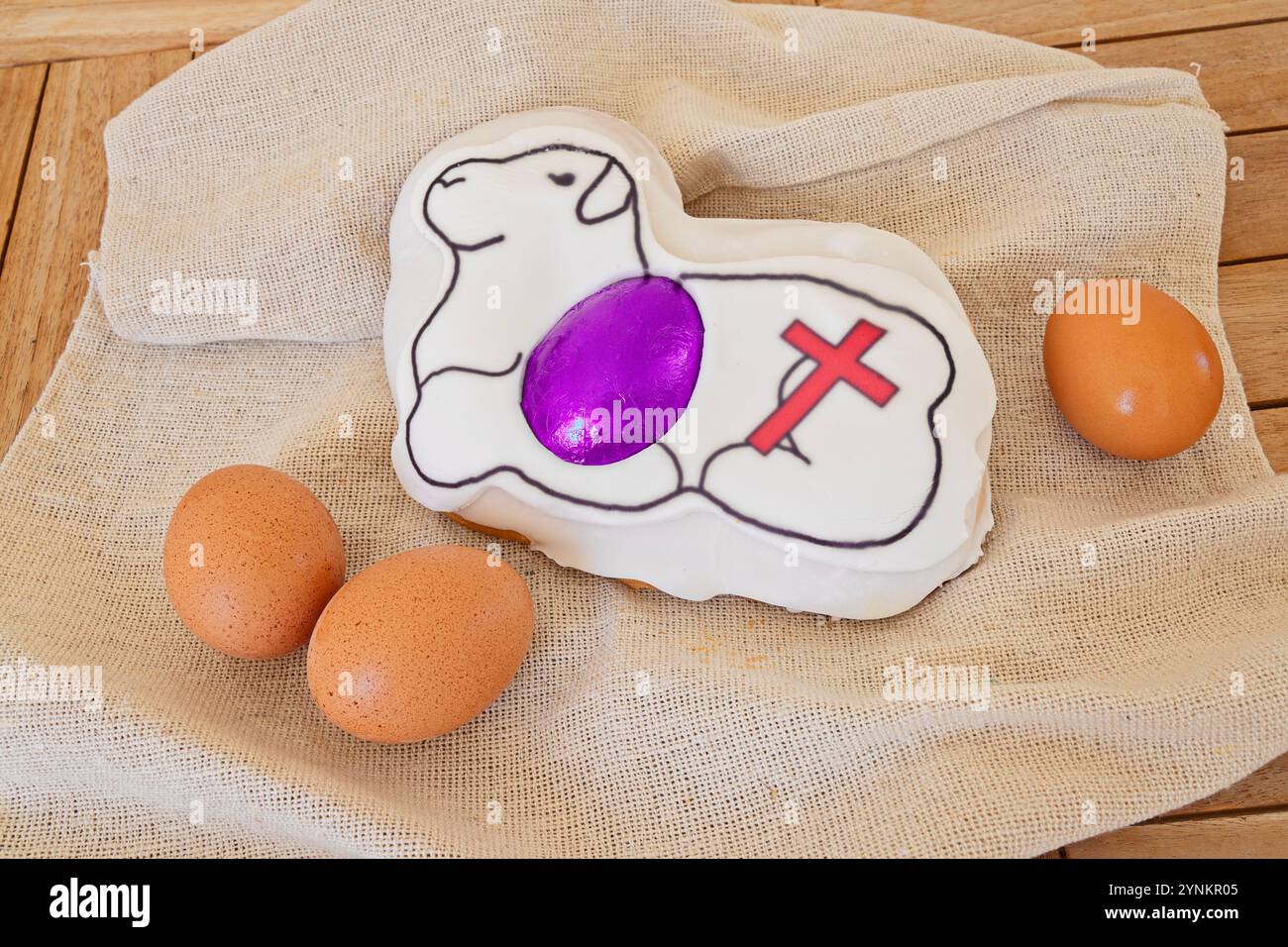 Easter lamb cake with symbolic cross and eggs on burlap cloth Stock Photo