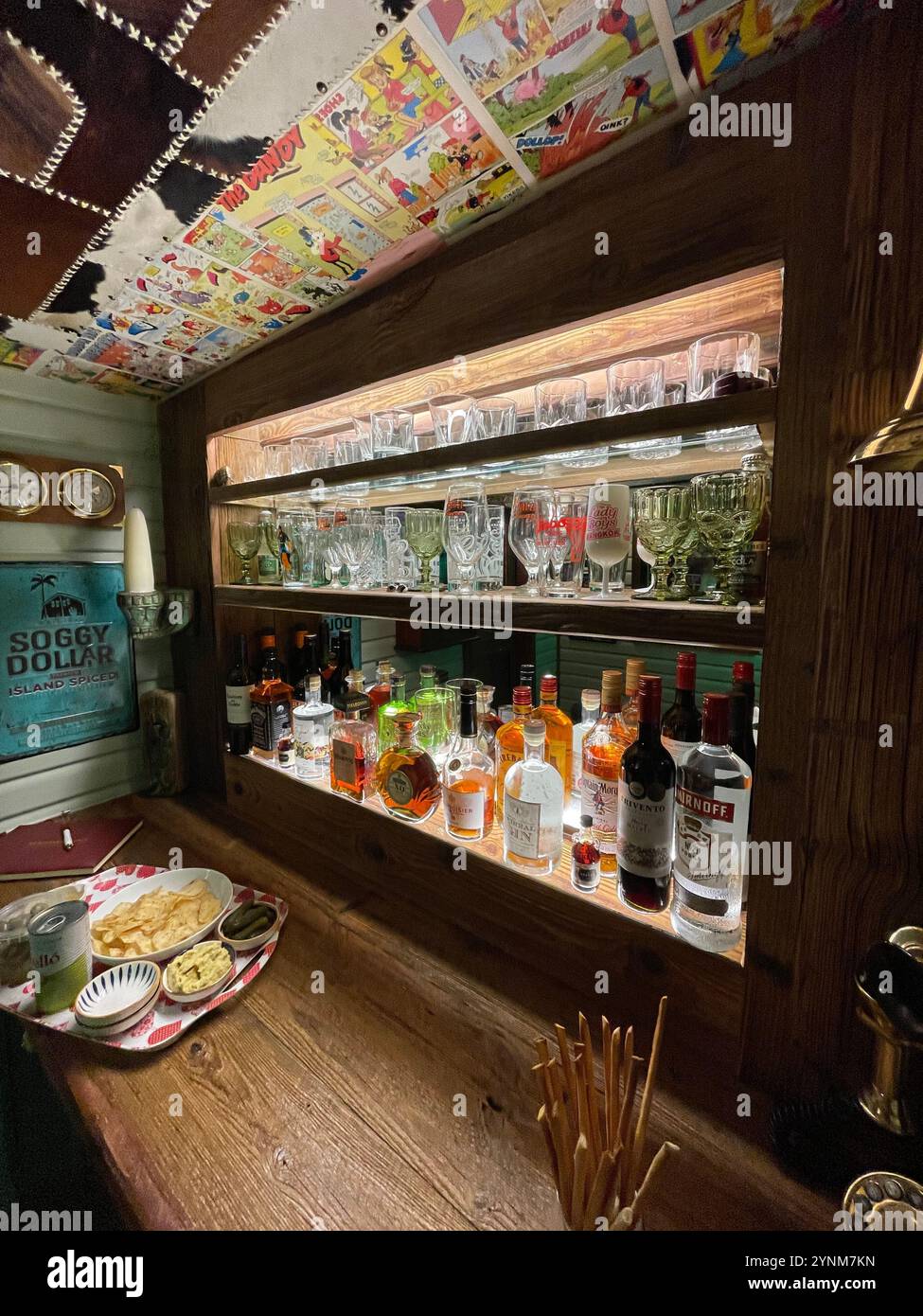 Spirit bar and comic pages pasted to the ceiling of a 'man cave' home bat, Cheshire. UK - Smartphone Captured Stock Image