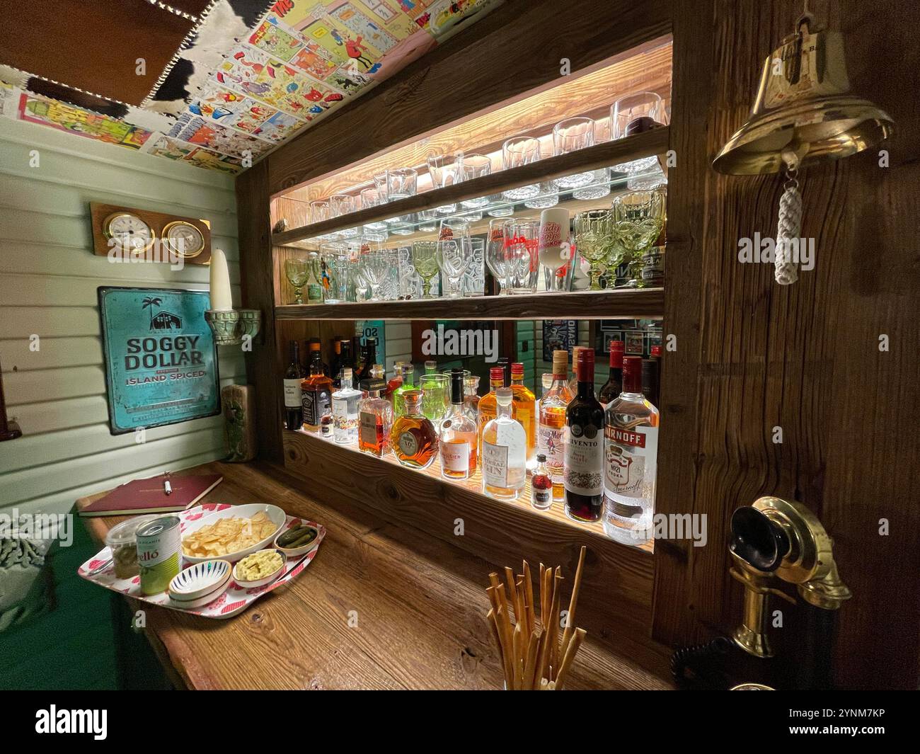 Spirit bar and comic pages pasted to the ceiling of a 'man cave' home bat, Cheshire. UK - Smartphone Captured Stock Image