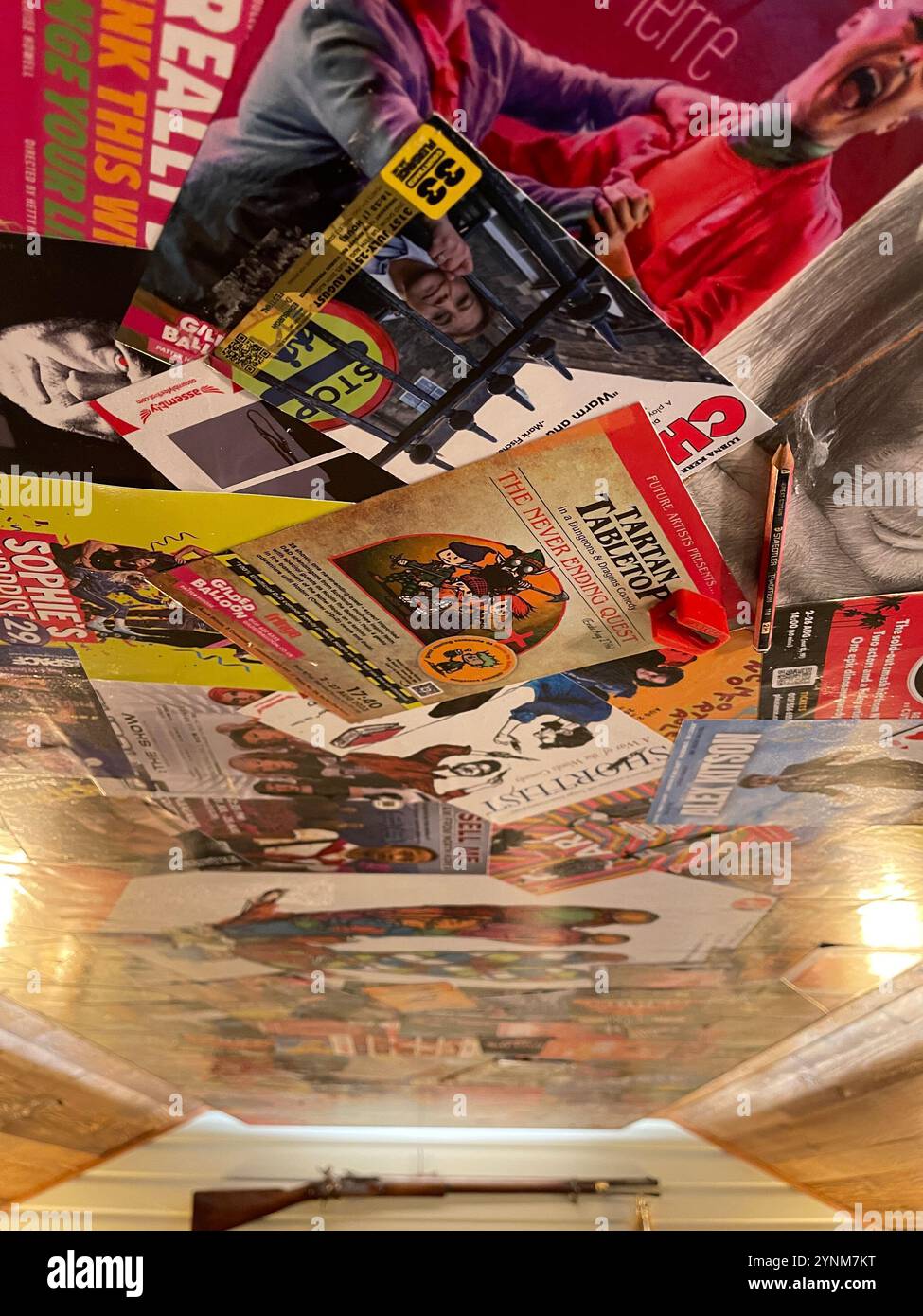 Event flyers pasted to the ceiling of a 'man cave' home bat, Cheshire. UK - Smartphone Captured Stock Image