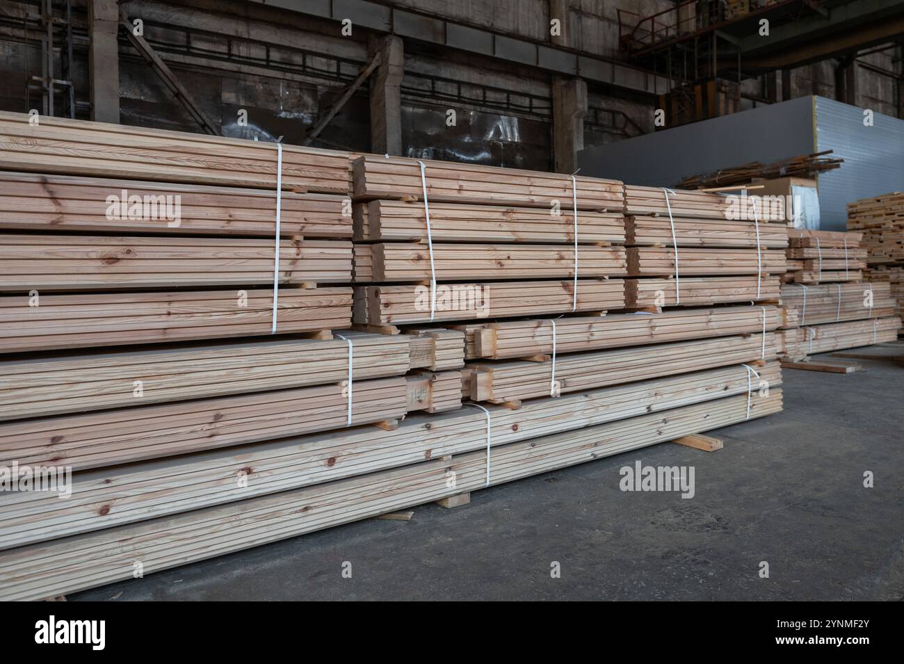 Stacked wooden planks close-up at lumber warehouse. Wood industry ...