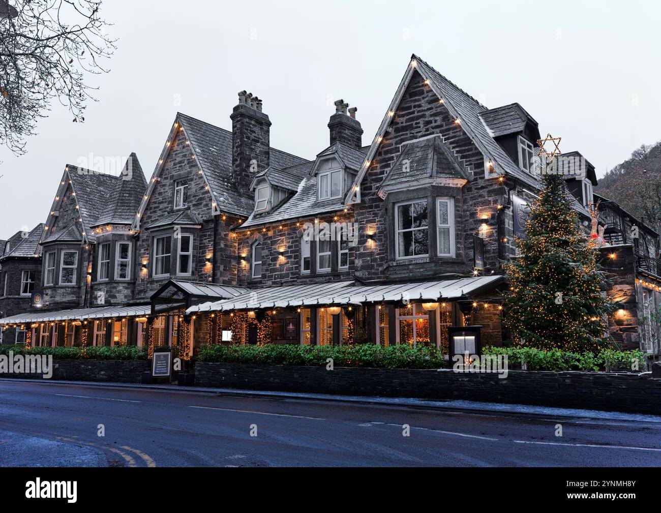Cwydyr House hotel and its christmas decorations in the tourist village of Betwys y Coed, Wales, on a early morning winter day. Stock Photo