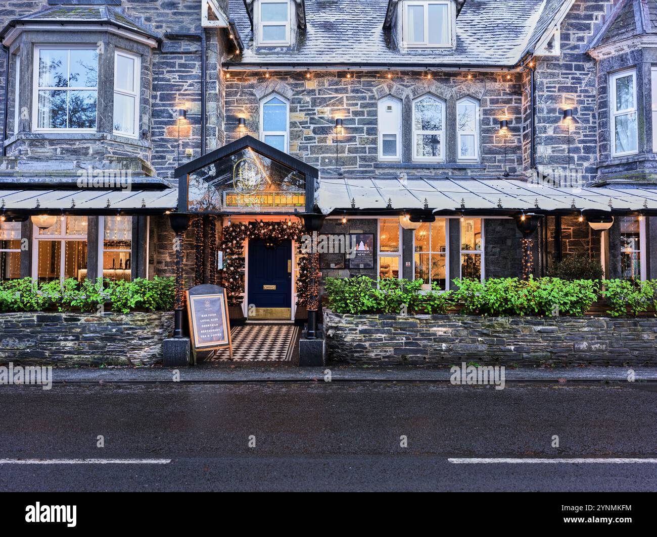 Cwydyr House hotel and its christmas decorations in the tourist village of Betwys y Coed, Wales, on a early morning winter day. Stock Photo