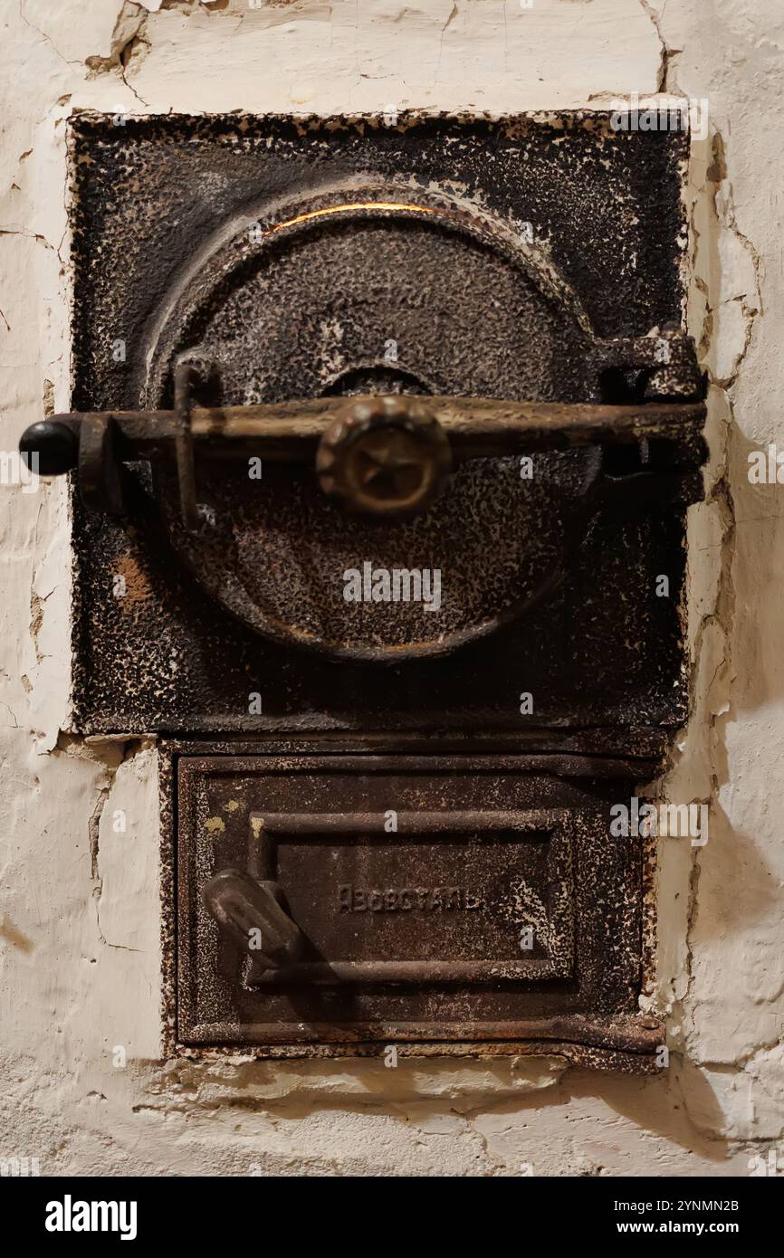 Antique cast iron furnace door with intricate details and a weathered ...