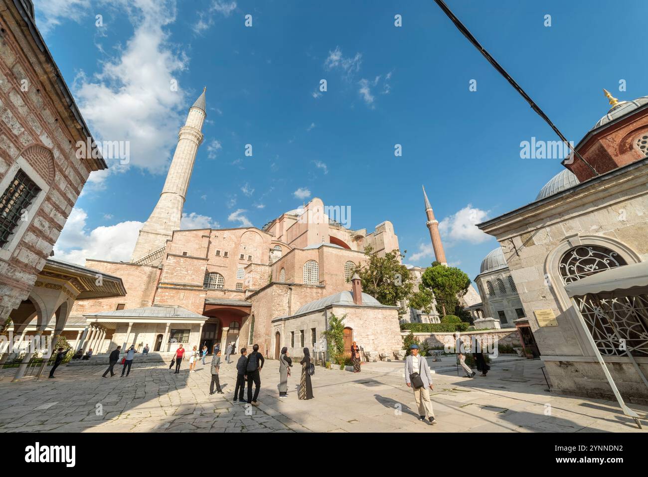 Tourists walking at the outer grounds of Hagia Sophia, Hagia Sophia is a former Orthodox patriarchal basilica, later a mosque now (2024) Stock Photo