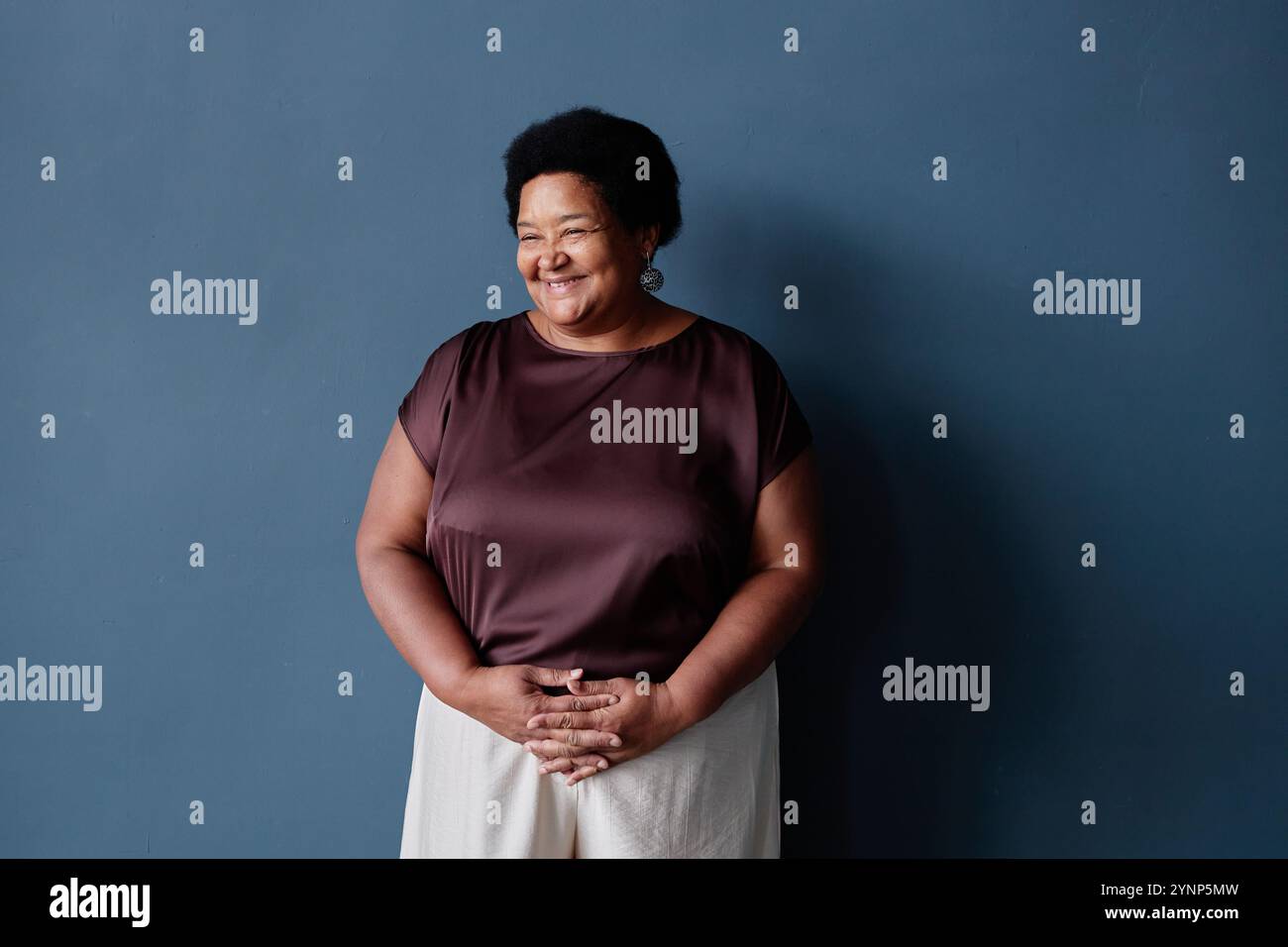 Minimal waist up portrait of kind African American senior woman ...