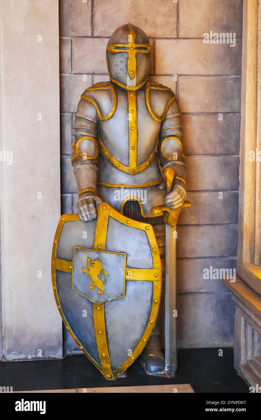 statue of a medieval European knight in armor with a sword and shield ...