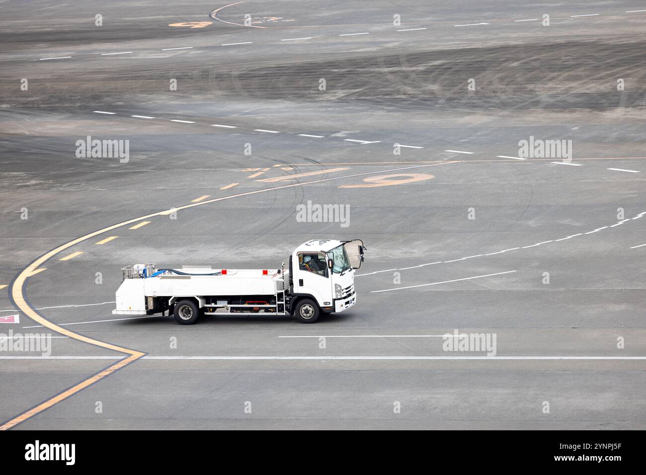 Airport fuel truck driving on the tarmac Stock Photo - Alamy
