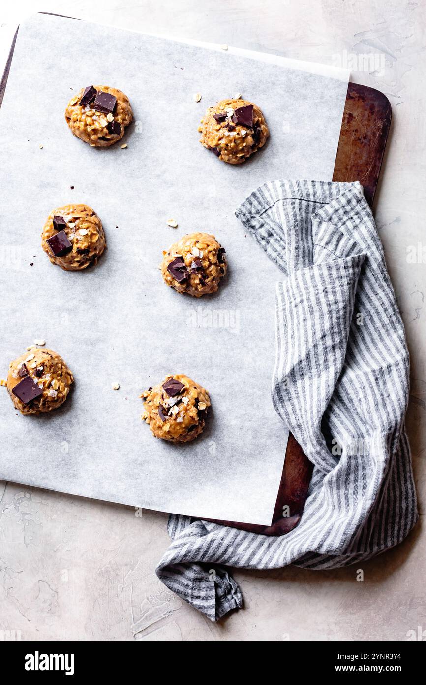 Oatmeal chocolate chip cookie dough scoops on a cookie sheet Stock Photo