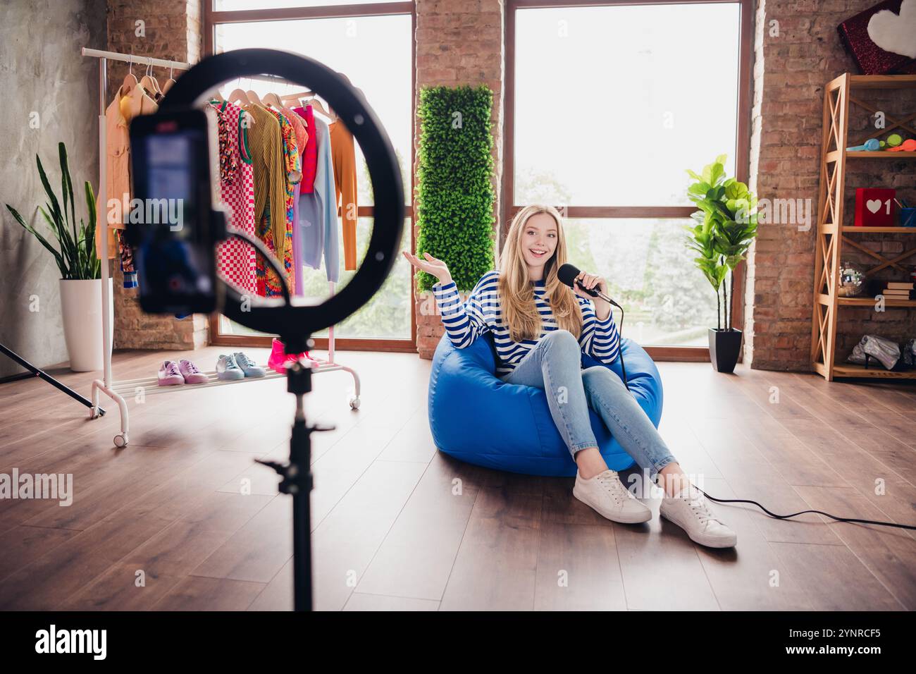 Photo of cheerful cute girl blogger telling story recording video ...
