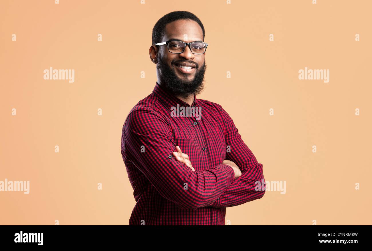 Smiling afro man posing on yellow background Stock Photo