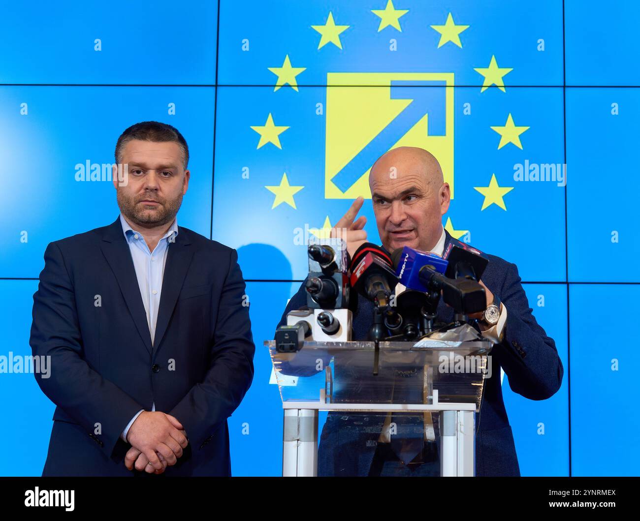 Bucharest, Romania. 26th Nov, 2024: The new interim president of the National Liberal Party (PNL), Ilie Bolojan (R), president of the Bihor County Council, holds a press conference about the party's future following the resignation of the PNL president, Nicolae Ciuca, after failing to advance to the second round of the presidential elections in Romania Credit: Lucian Alecu/Alamy Live News Stock Photo