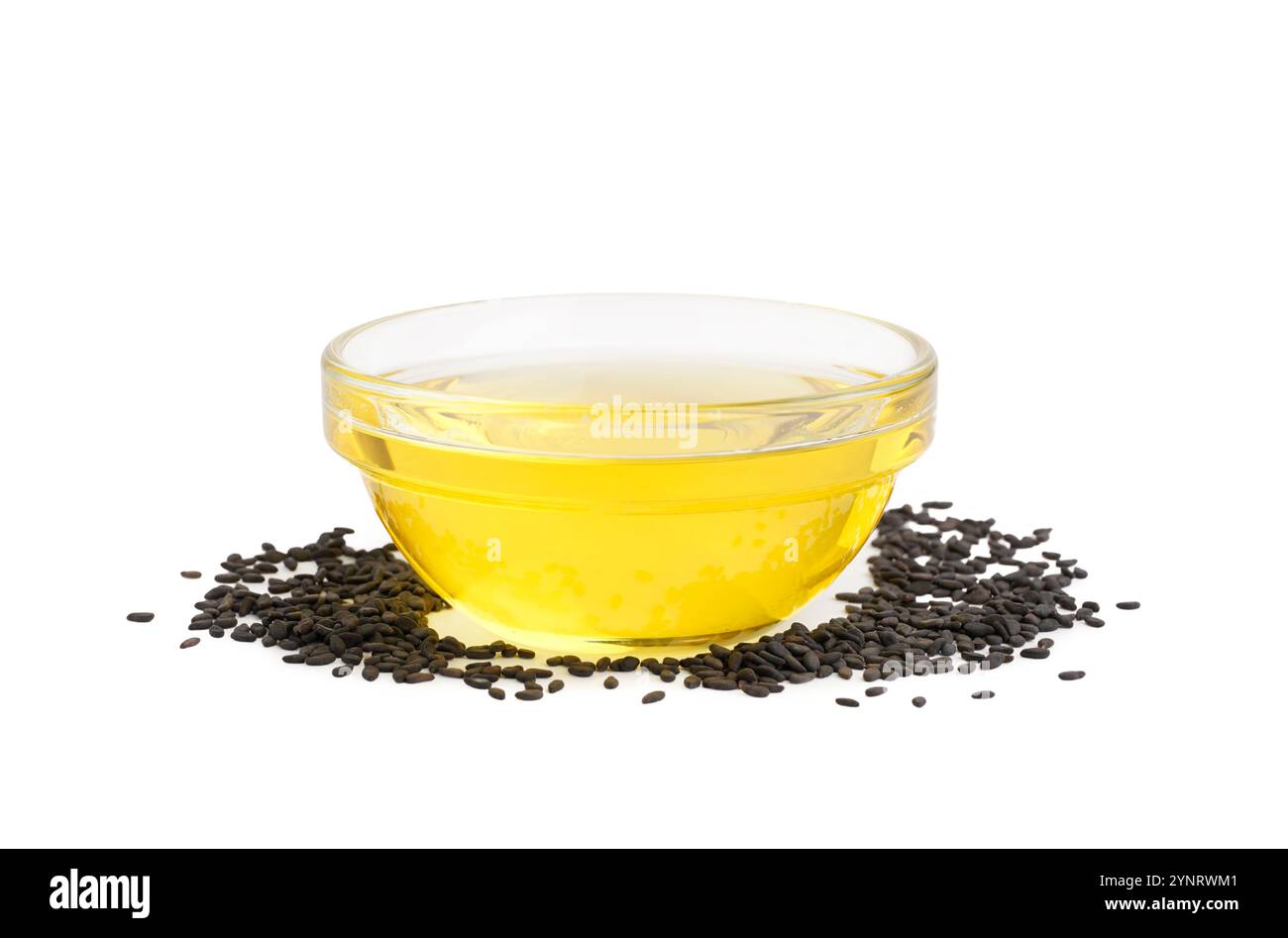 Sesame seeds and bowl of oil on white background Stock Photo - Alamy