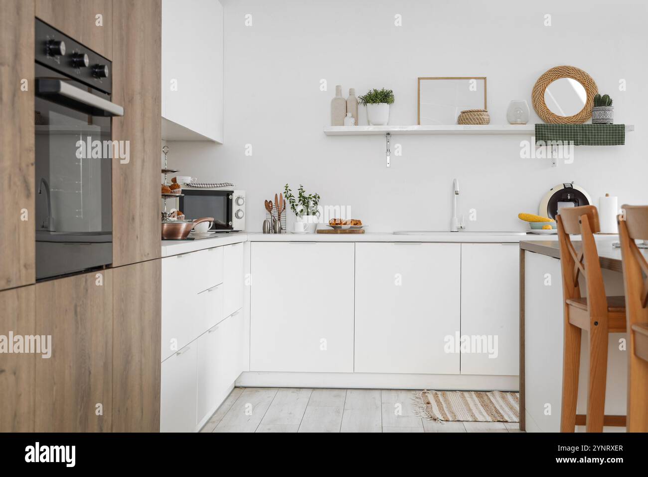 Interior of modern kitchen with white counters and shelf Stock Photo ...