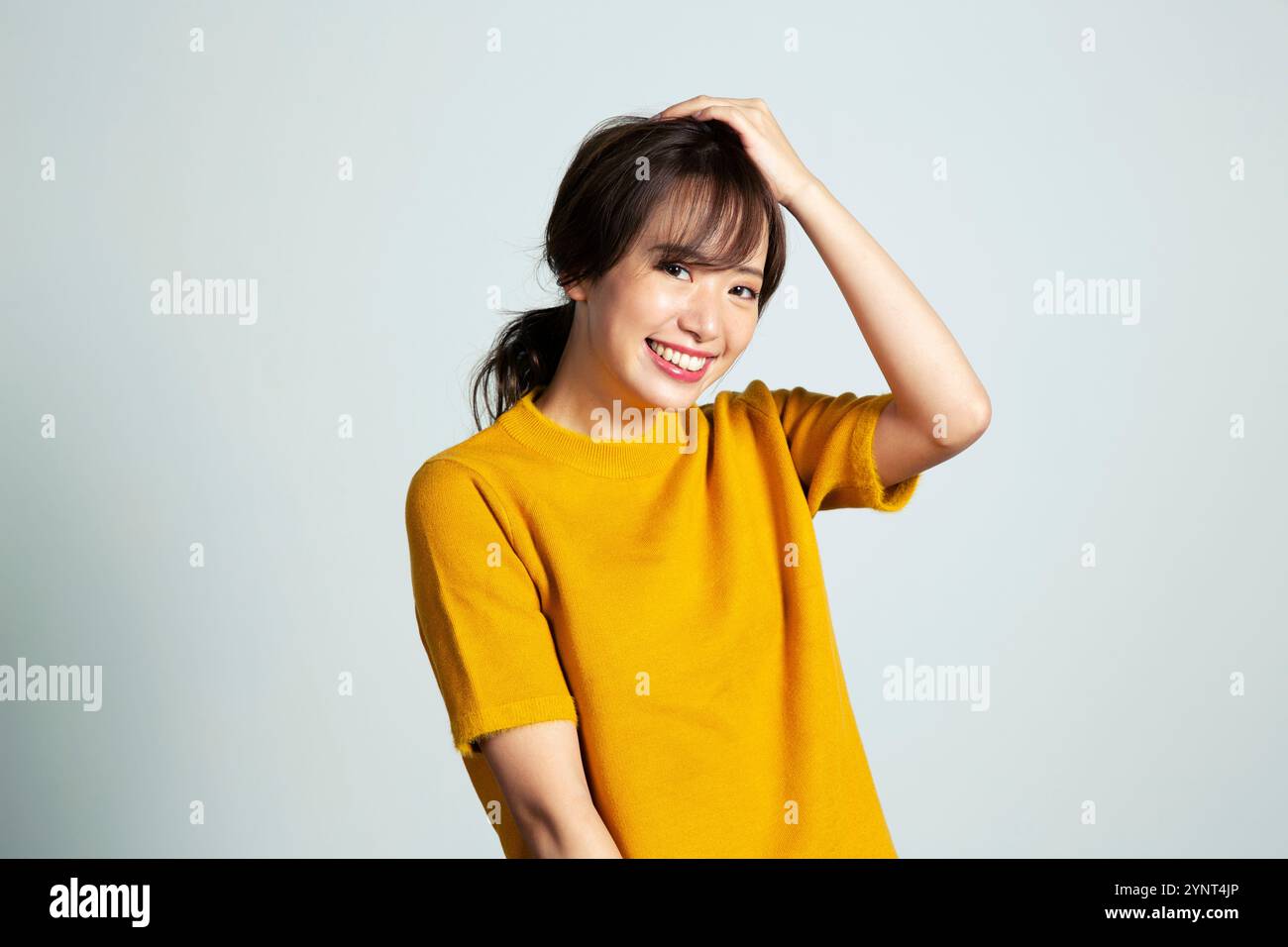 Woman in her 20s looking at the camera holding her head with her hand ...