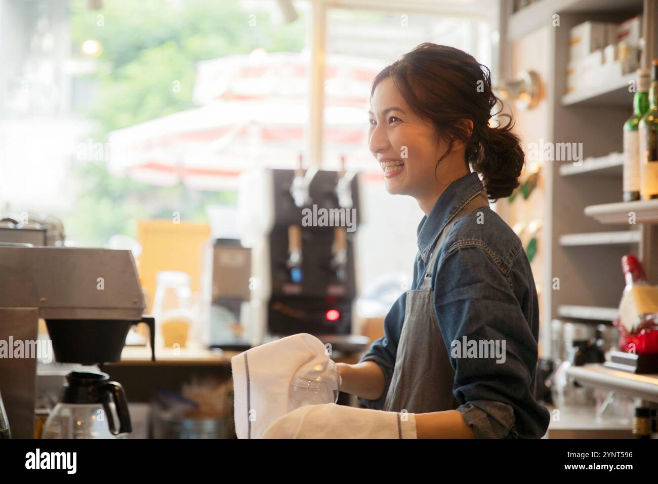 Woman in her 20s working in a café Stock Photo